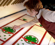 Bernadette places a stained glass window in the fusing oven